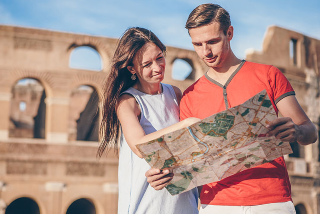 Tourist couple studying a map in front of ancient ruins, planning their next destination.