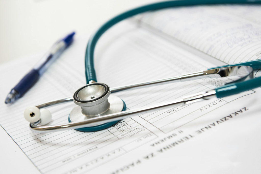 Stethoscope and pen on a medical chart, symbolizing healthcare, diagnosis, and patient records.