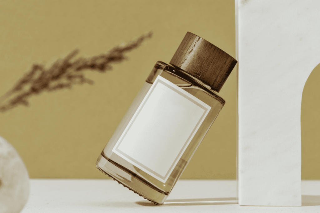 A perfume bottle with a wooden cap, leaning against a marble structure, with a minimalist design and soft, earthy background.